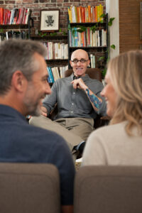 Dr. Murray sitting with a couple
